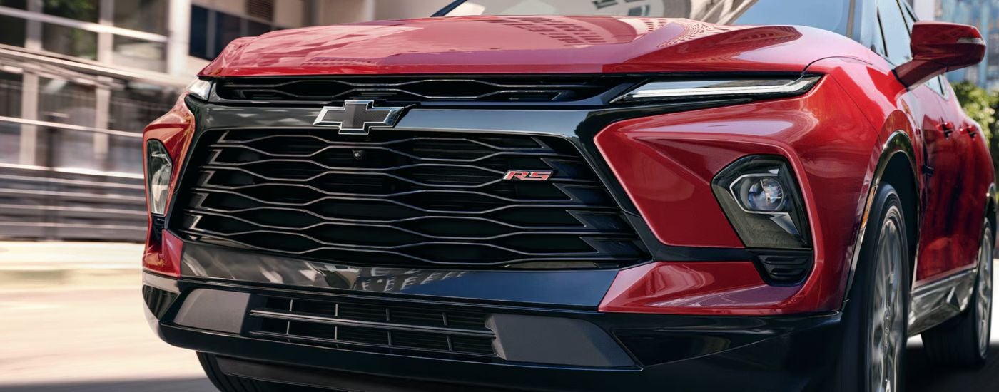 Close-up of the front grille on a red 2026 Chevy Blazer.