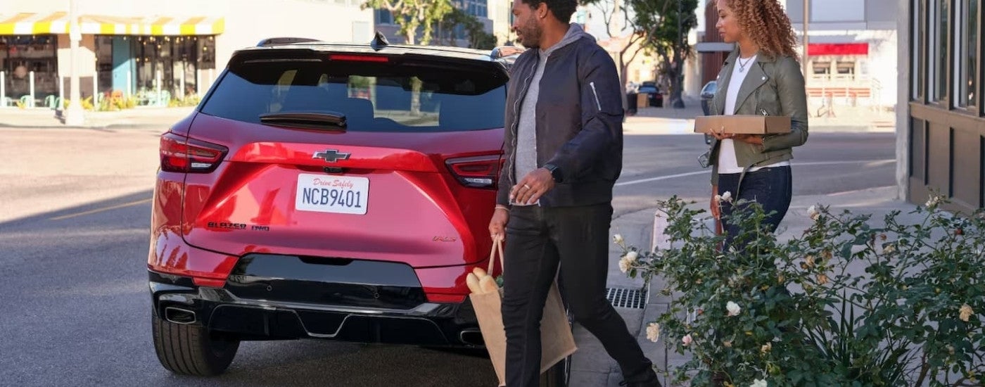 Red 2023 Chevy Blazer RS parked in front of a shop