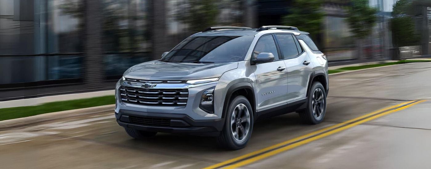 Silver 2026 Chevy Equinox driving through a city