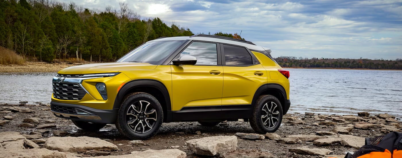 Yellow 2026 Chevy Trailblazer ACTIV parked near a lake.