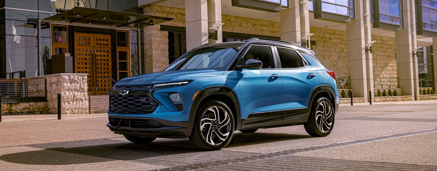 Blue 2026 Chevy Trailblazer RS driving down a road.