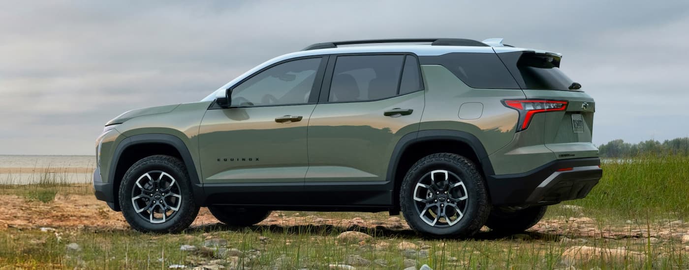 Side of a green 2026 Chevy Equinox ACTIV parked off-road.