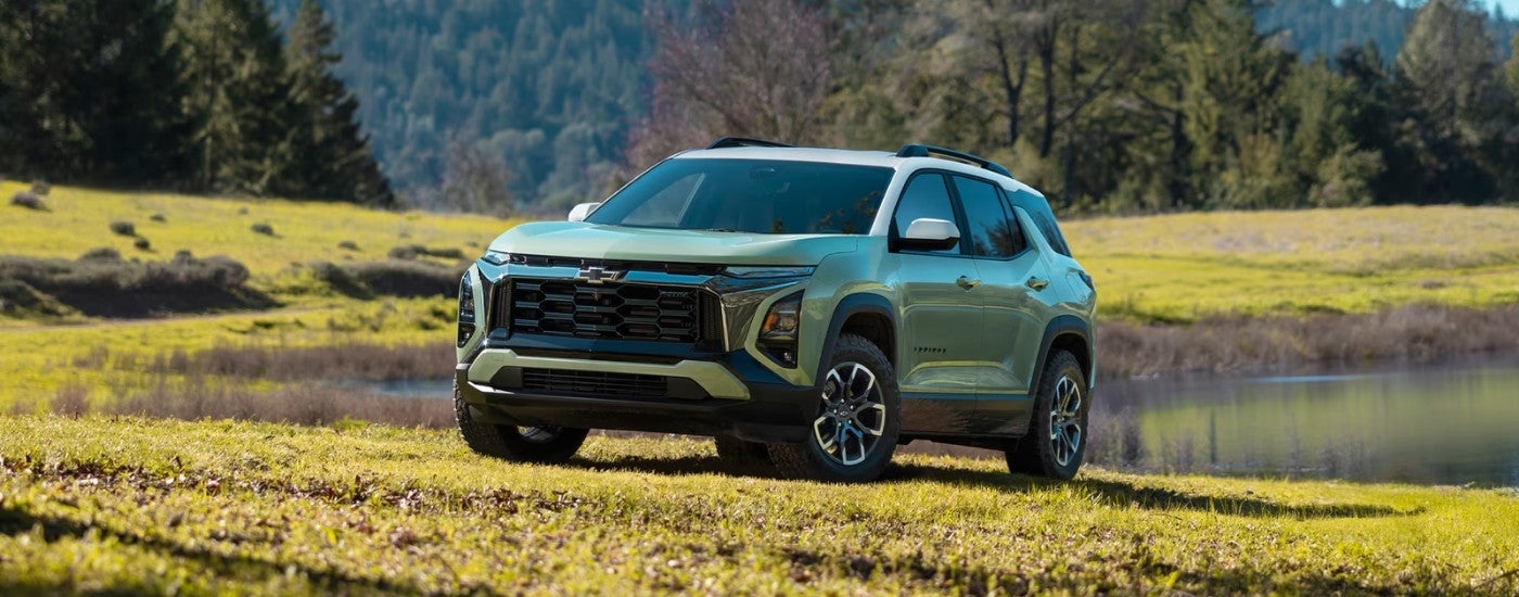 Green 2026 Chevy Equinox ACTIV parked near a lake
