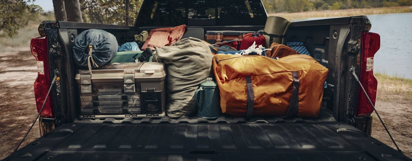 Gear in the bed of a black 2026 Chevy Silverado 1500 High Country