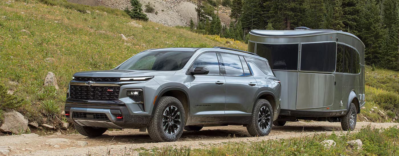 Silver 2026 Chevy Traverse towing a camper.