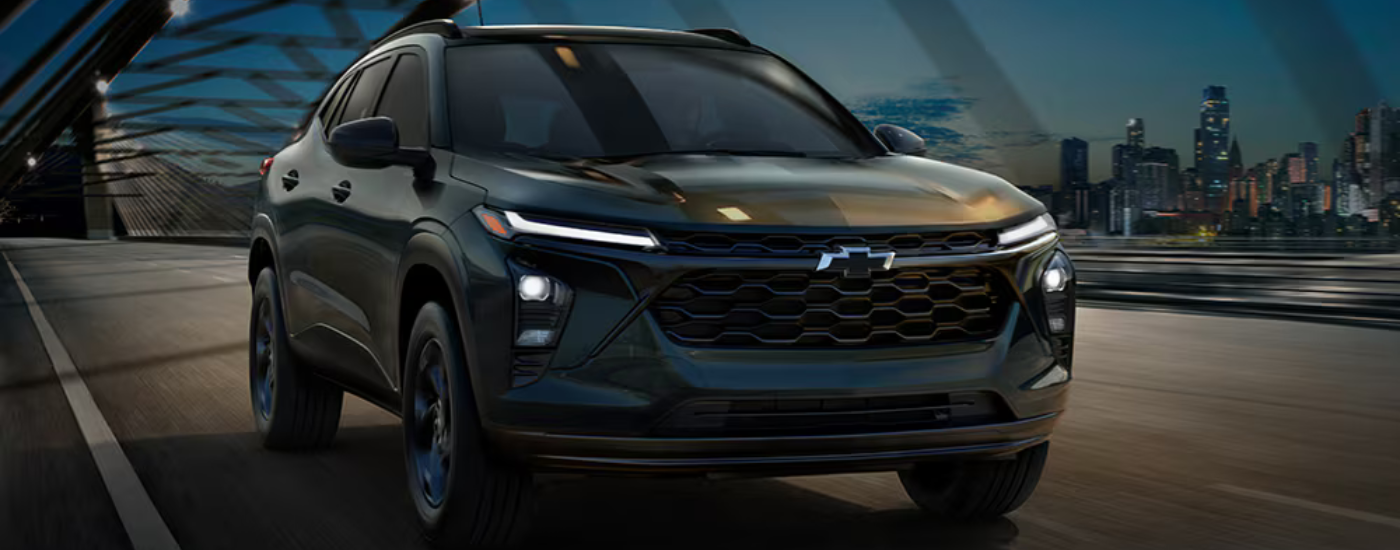 Black 2026 Chevy Trax driving over a bridge