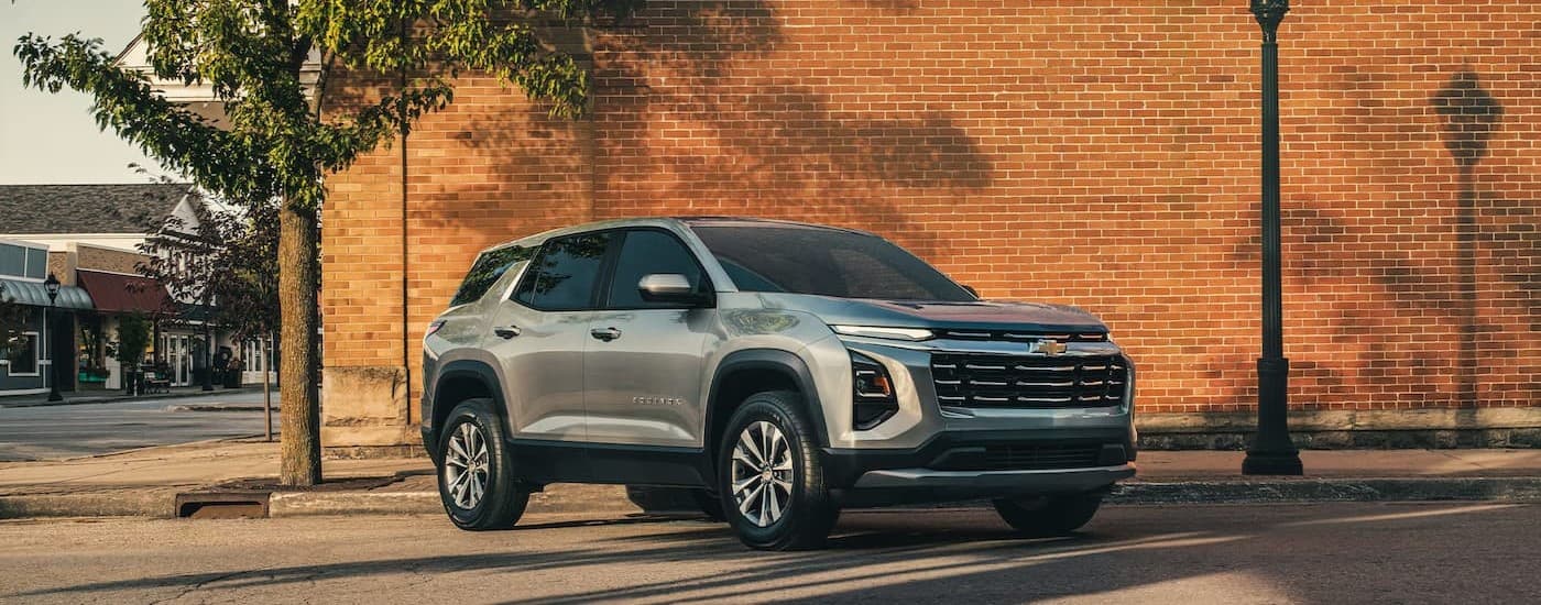 A silver 2026 Chevy Equinox parked in a city.
