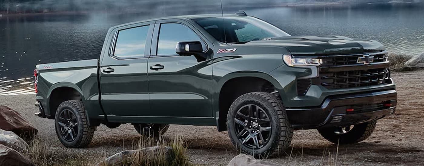 A green 2026 Chevy Silverado 1500 Z71 parked near water.