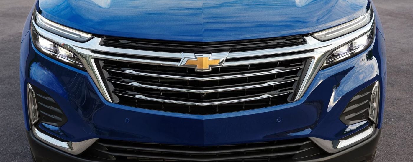 Front girlle of a blue 2023 Chevy Equinox.