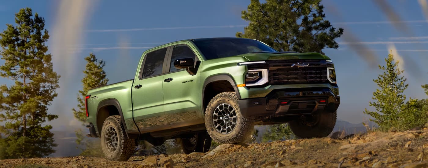 Green 2027 Chevy Silverado 1500 parked off-road on a hill.